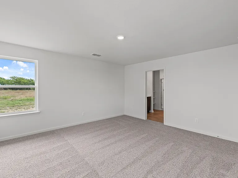 The master suite has a spacious bedroom, en-suite bathroom and walk-in closet.