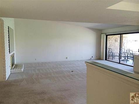 Standing at the entry looking into the living room. The living room has views to he golf course and 