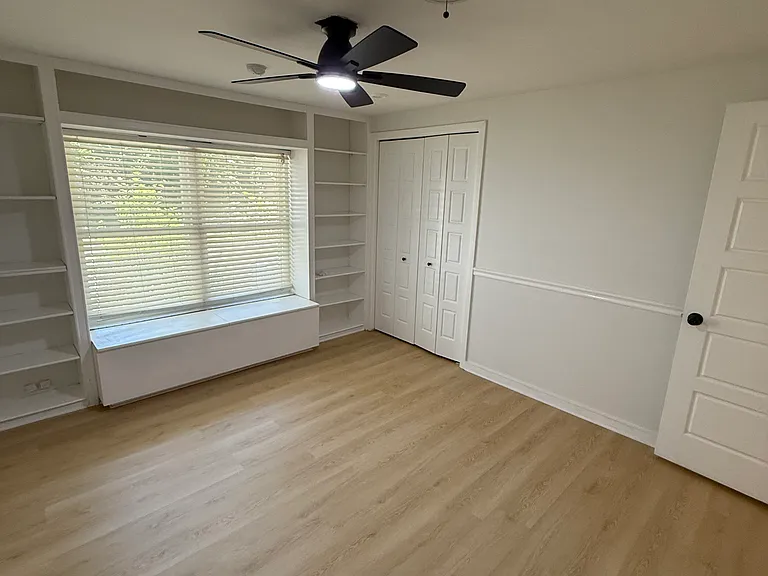 Bathroom with built in bookshelves and window bench