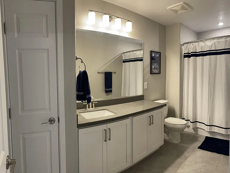 Third floor full bathroom with upgraded faucets and linen closet