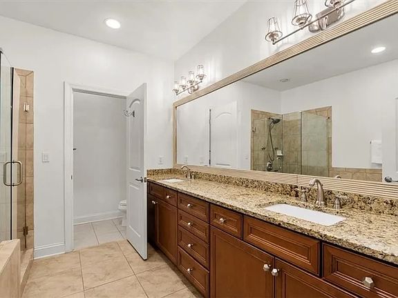 Primary bathroom with dual vanity, bath-tub and walk-in shower