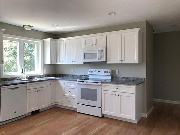 Kitchen with granite countertops, hardwood floors