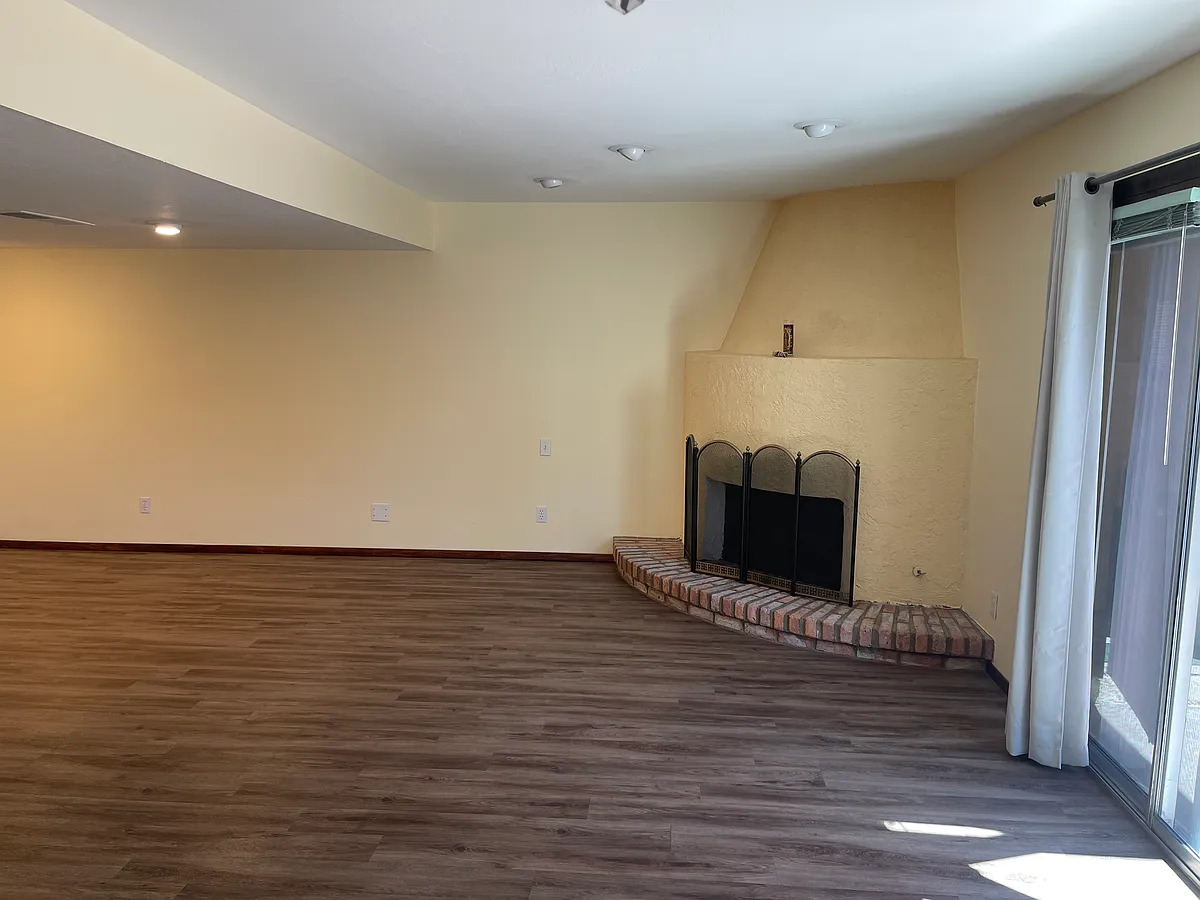 Family room with doors to private courtyard, laundry and parking - 6533 N 7th Ave #13