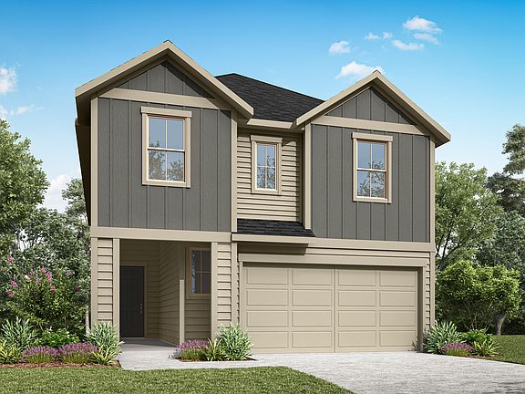 A two-story residential house with a garage, surrounded by lush greenery and a paved driveway in the