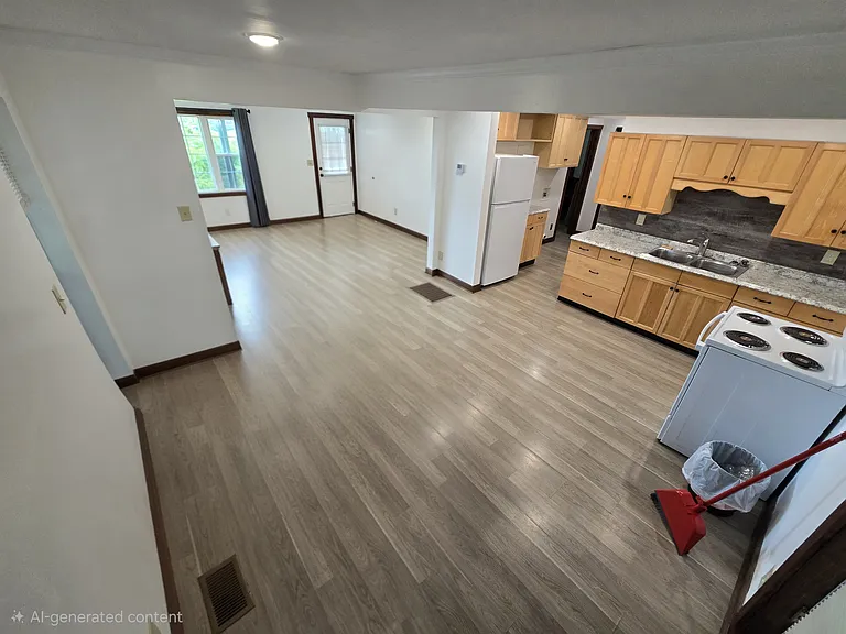 View from the back door of the eat in kitchen with open floorplan to living room. (Photo editing used to remove furniture in order to give a better understanding of the space.)
