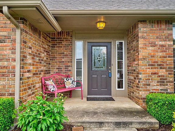 Front door with beautiful landscaping.