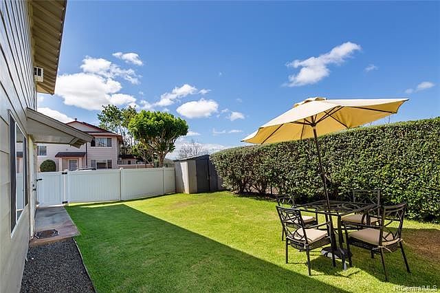 This yard has irrigation so you don't have to water the grass.  Nice hedge that offers privacy- no neighbors on the other side (