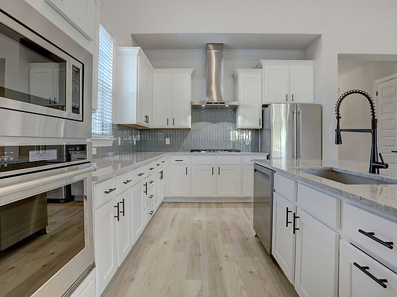Chef-ready kitchen with stainless steel appliances and a timeless elegance.