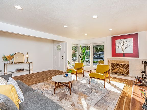 Living room is anchored by wood-burning fireplace