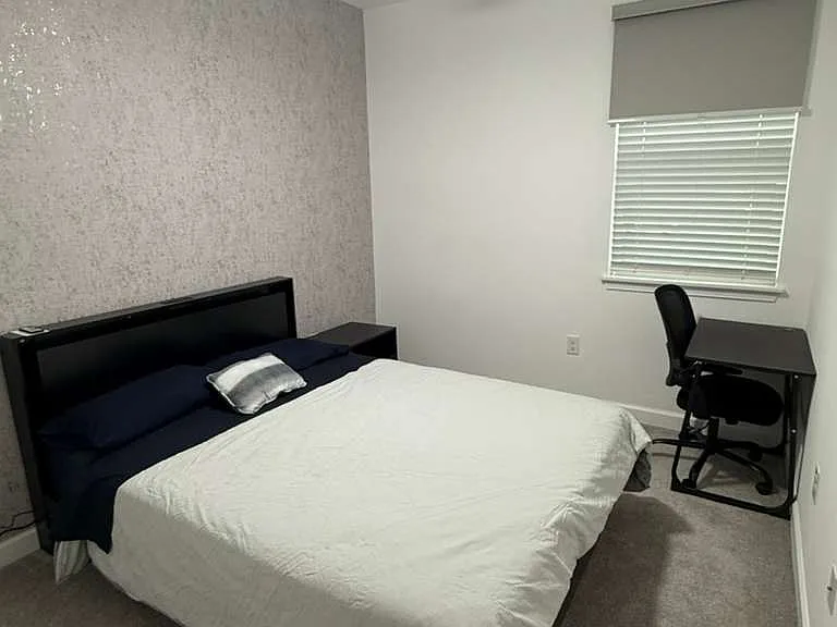 Second floor first bedroom. Includes blackout blind, queen bed with matress, nightstand, and desk with chair.