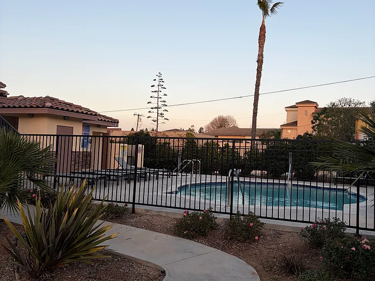 Community swimming pool with jacuzzi. Beautiful view from the unit window.
