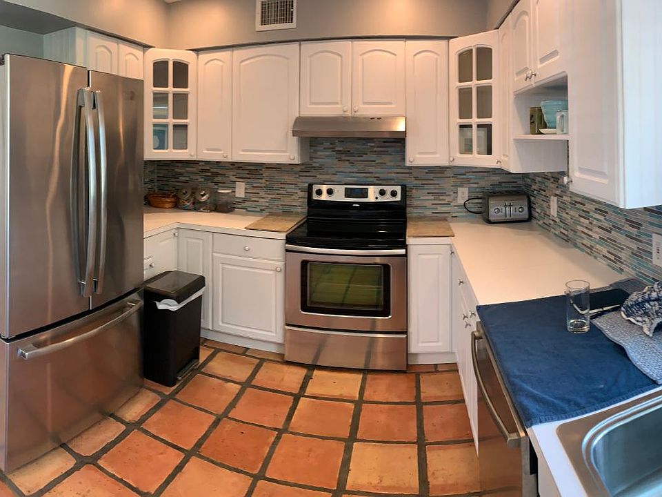 Large spacious kitchen with updated stainless steel appliances, beautiful window overlooking huge backyard.