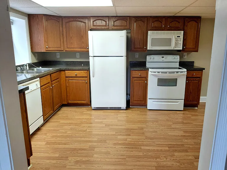 Full kitchen with extensive cabinetry, ample counter space, and essential appliances