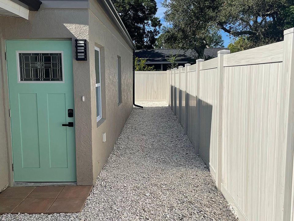 When you come through the fence gate to small yard for either car or storage to front door, side leads to back area
