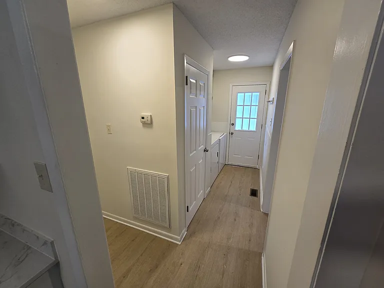 Laundry area and side door to covered car port.