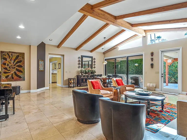Great room with view to kitchen and upright piano.