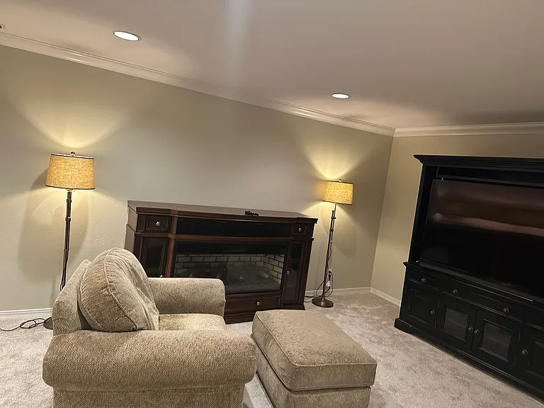 It is a comfy place beside the electric fireplace for TV time