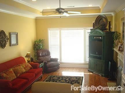 Family Den
						:
						Den area includes wood floor, high ceiling, and wood/gas fireplace.