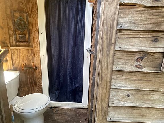 Bathroom connected to tiny house on wheels but only accessible from outside.