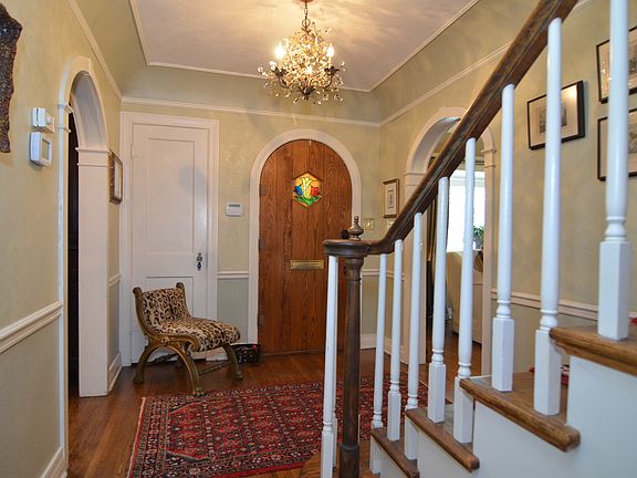 Lovely Entry with Venetian Hand Painted Plaster Walls, Refinished Hardwood Floors and the Original Restored Arched Front Door