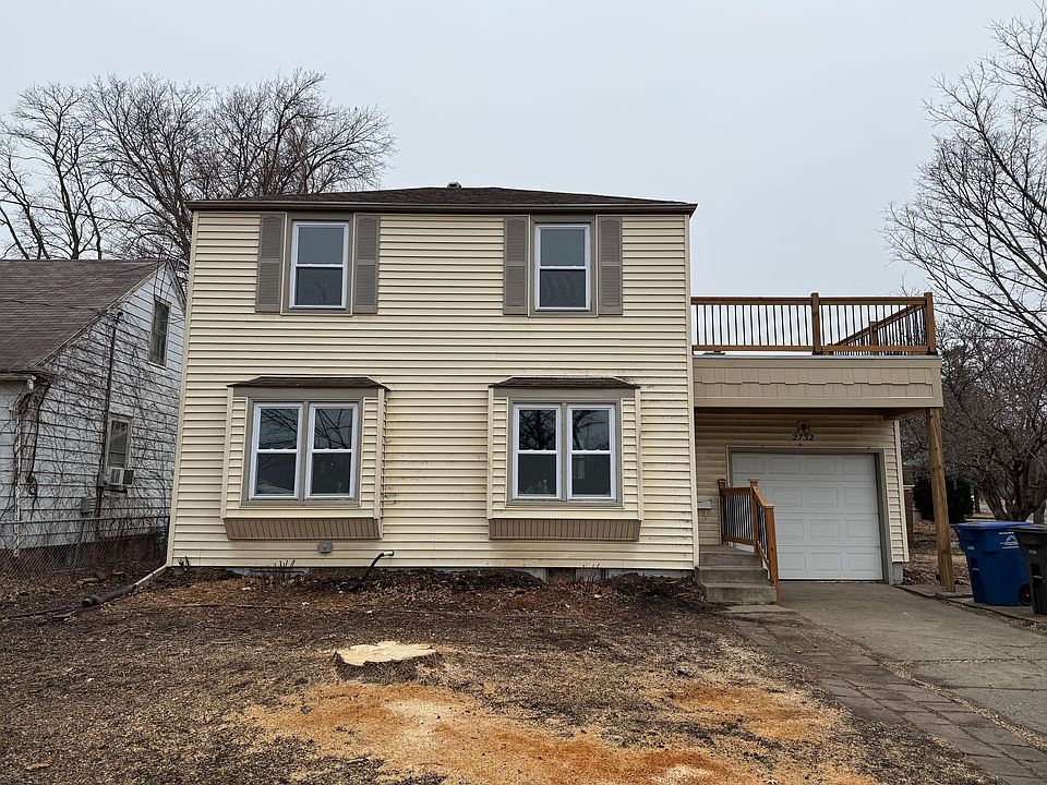 Front of house. Front door is up three steps to the left of the garage.