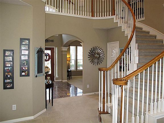 Impress your guest with this gorgeous winding staircase and high ceilings