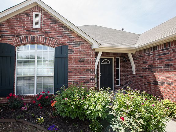 LOVELY FLOWER BED ADORNS THE FRONT PATH