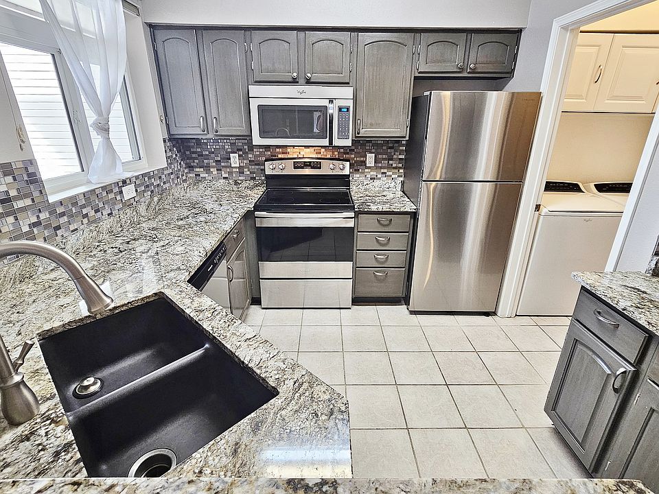 Custom Granite Kitchen, Glass Tile Backsplash, Stainless Steel Appliances, Adjacent Laundry Room with Full Size Washer & Dryer