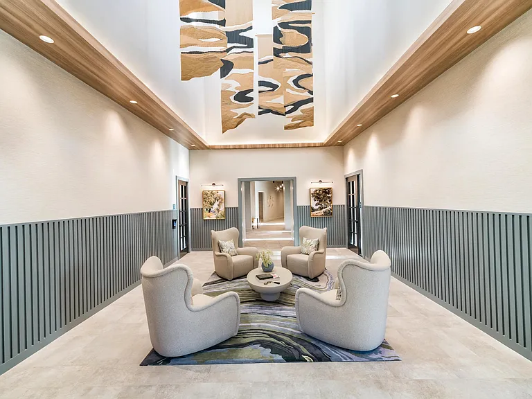Striking ceiling details and cozy conversation seating make this lounge a stylish and welcoming retreat within the Modera South Shore clubhouse.