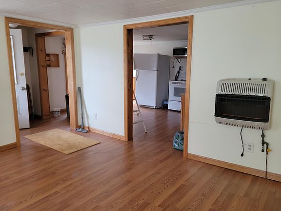 Living room looking into kitchen and entrance