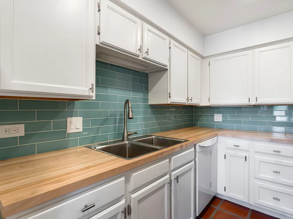 New tile and new butcher block counters in kitchen