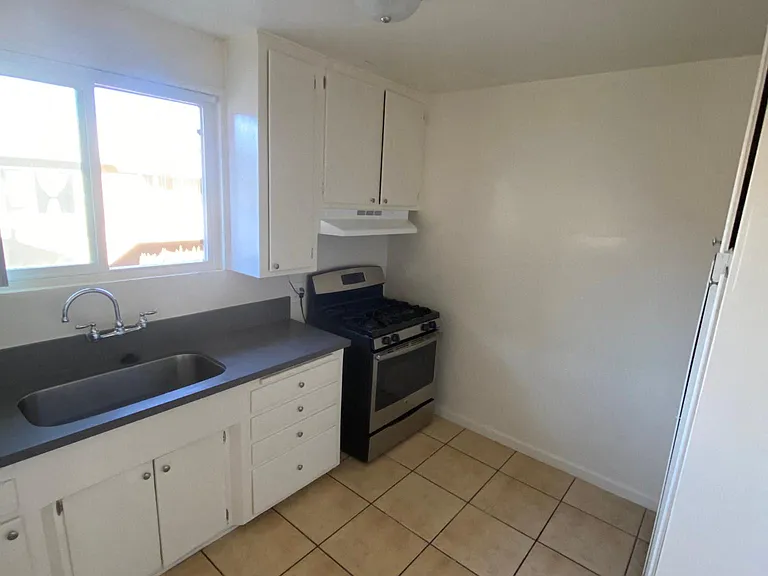 Kitchen with natural light and spacious cabinets at Edison Apartments in Burbank, California.