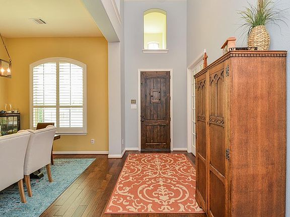 View of entry. Gleaming hardwoods throughout main living areas and Plantation shutters on front windows and master.