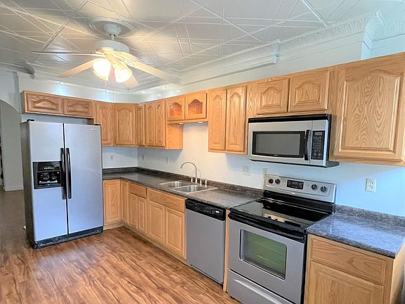 Beautiful kitchen 16 x 9 with oak cabinets, flat top stove with built in microwave, dishwasher, refrigerator with ice maker.
