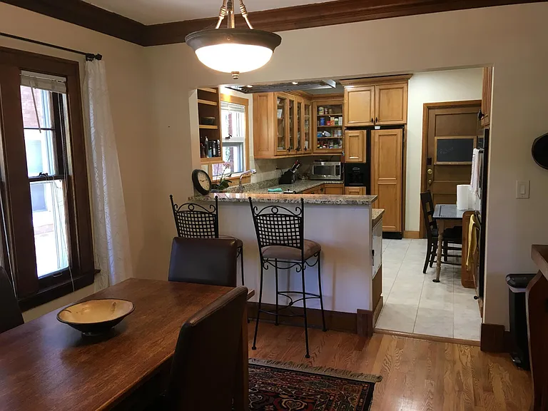 Breakfast bar w/granite countertop. Lots of cabinets in the kitchen