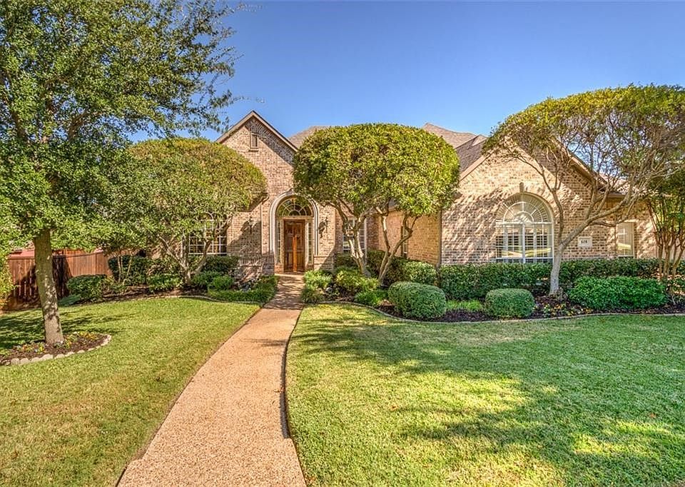 Beautifully landscaped front and rear yards. Aggregate walk. All brick construction. Side driveway with split bay garage. Exterior security lighting.