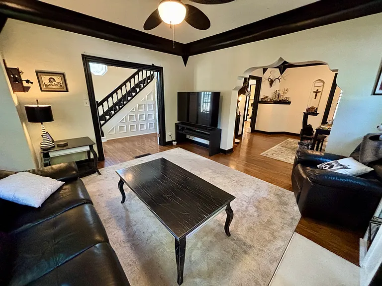 Shared living room with seating, fireplace, TV