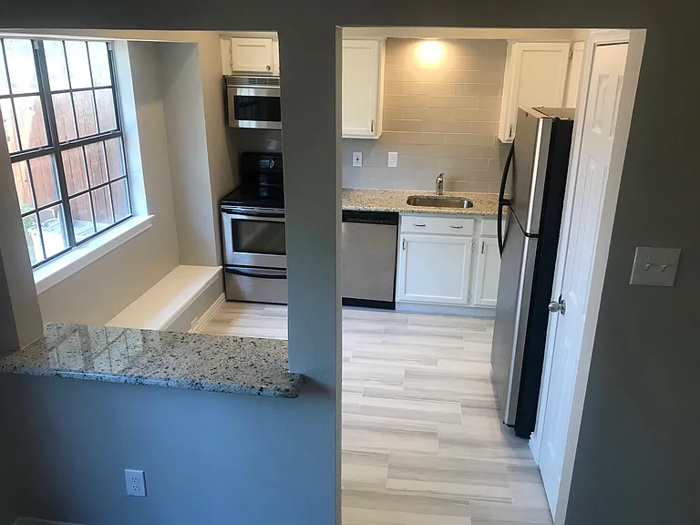 kitchen includes large window seat and an extra pass-through counter that is shared with the dining room - great for entertaining!