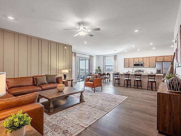 This home features a light-filled, open-concept living area - Monroe by Highland Homes