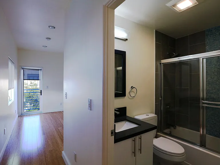 Bathroom and Front Bedroom with Balcony Door Opened