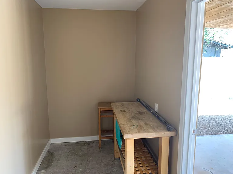 Outdoor laundry room comes with extra storage space, easily accessible to the kitchen.