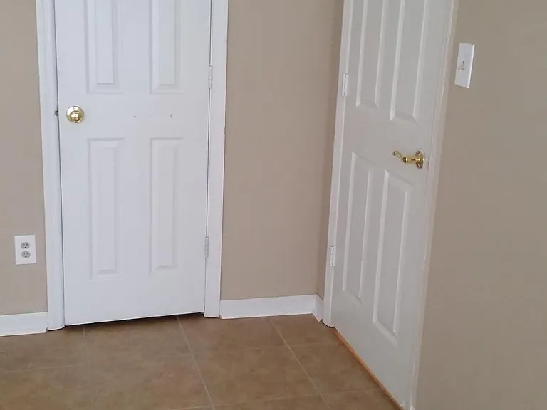 Entry from the hall and closet door in downstairs bedroom