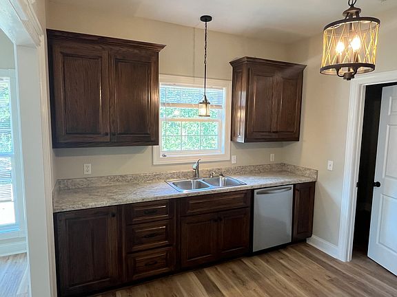 10x12 Kitchen area (just past Dining Room) with Dishwasher and Sink facing the open yard, Oak Cabinets with Marble-look Formica countertops