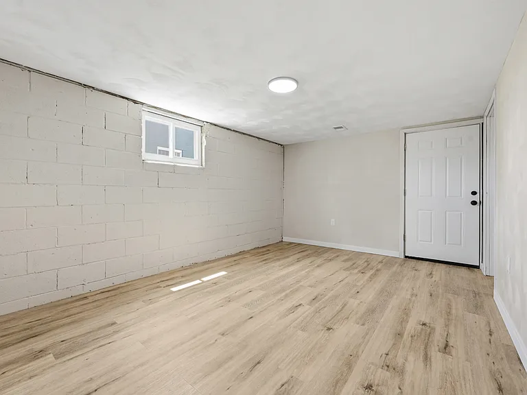 Partially finished basement. New LVT flooring, paint, electric, and fire door.