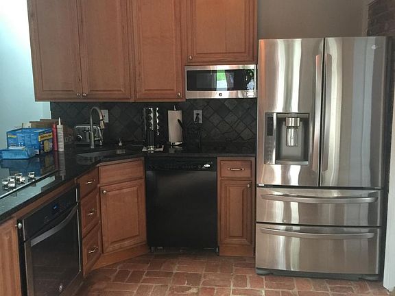Open format kitchen with stainless/black appliances