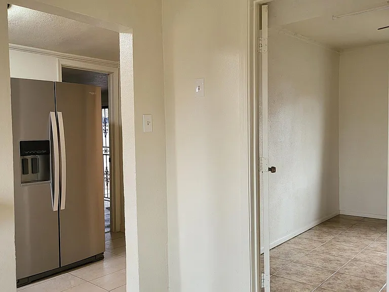 Another Angle Leading to Kitchen, back bedroom, and small updated bathroom