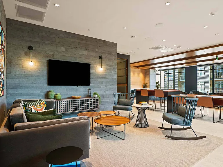 Experience a spacious lounge with plenty of seating, including cozy rocking chairs for added comfort.