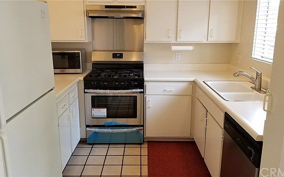 Kitchen features brand new, never-before used stove and hood, newer dishwasher and newer refrigerator. Window conveniently locat