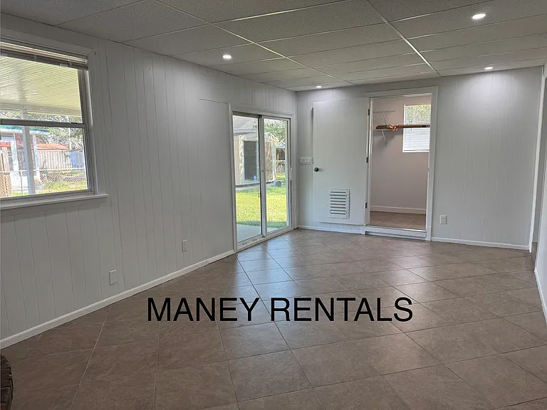 Bonus room, patio door and laundry room/storage, view of backyard shed