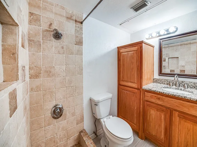 Primary master bathroom with good storage that is ensuite.